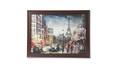 Framed artwork of a city street scene with the Eiffel Tower.