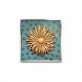 Decorative wall art above a console table with a lamp and plant in a room.