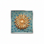 Decorative wall art above a console table with a lamp and plant in a room.