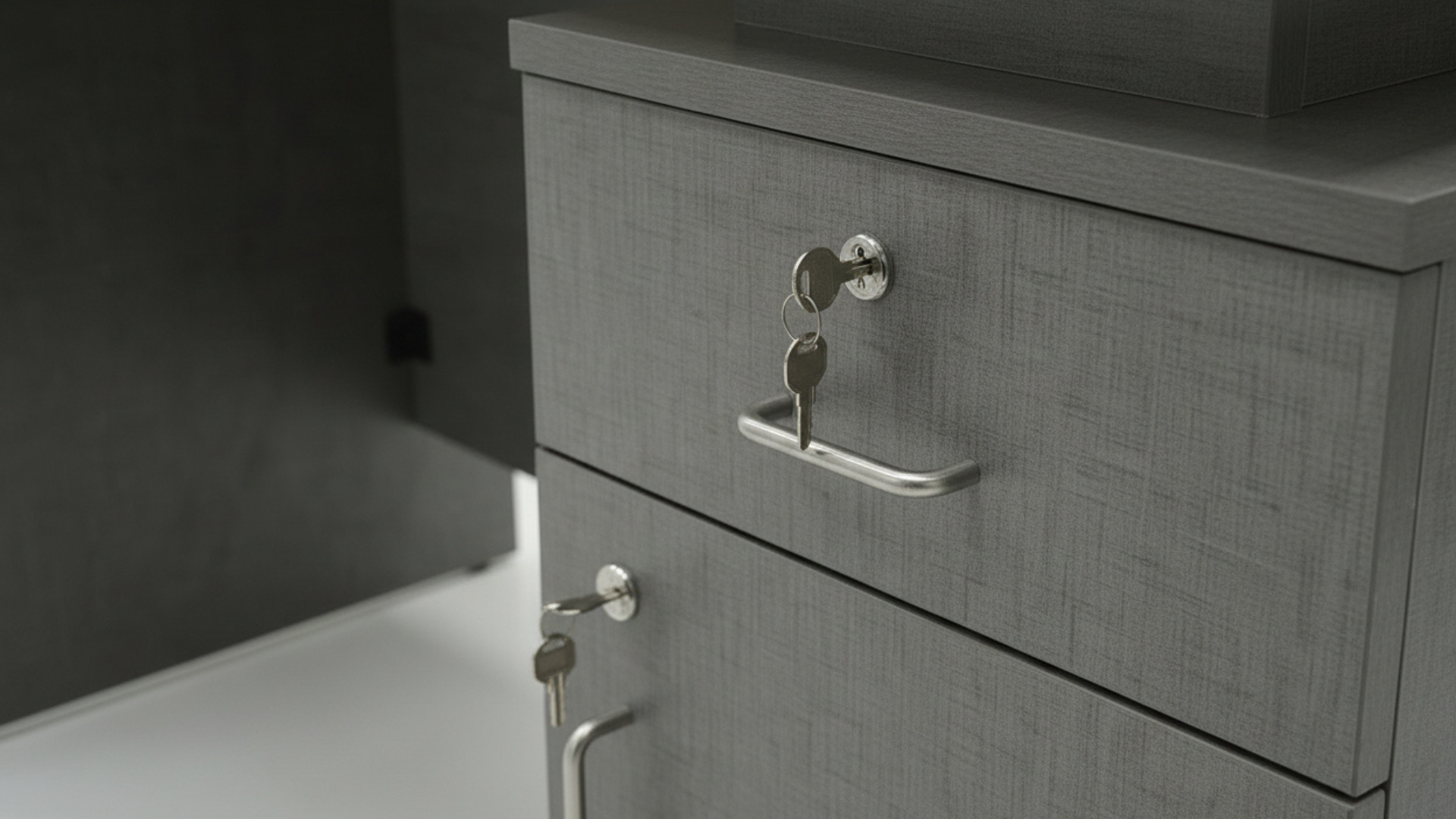 Gray cabinet with a key on a dark background