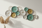Decorative wall art with circular plates in various colors on a light background