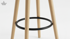 Wooden bar stool with a black metal ring on a white background
