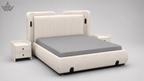 A modern upholstered bed with a tall segmented headboard and matching footboard in warm off-white fabric, shown with a gray mattress. Two matching side tables are placed beside the bed on a light gray studio background.