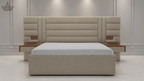 Beige upholstered bed with wooden accents against a white wall