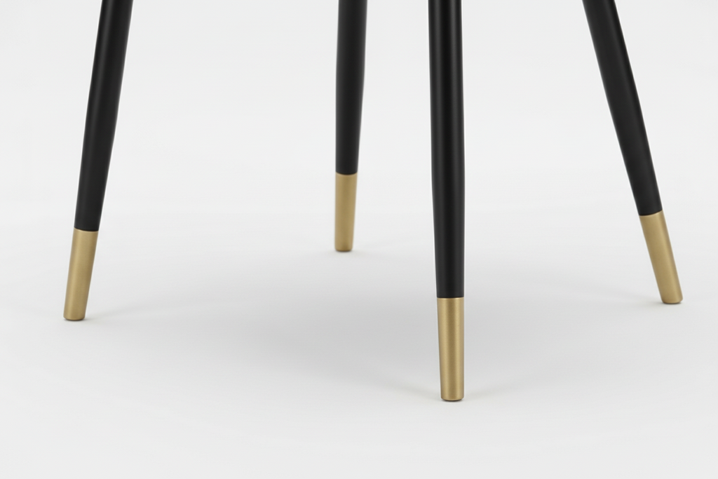 Blue upholstered chair with black legs and gold feet on a white background
