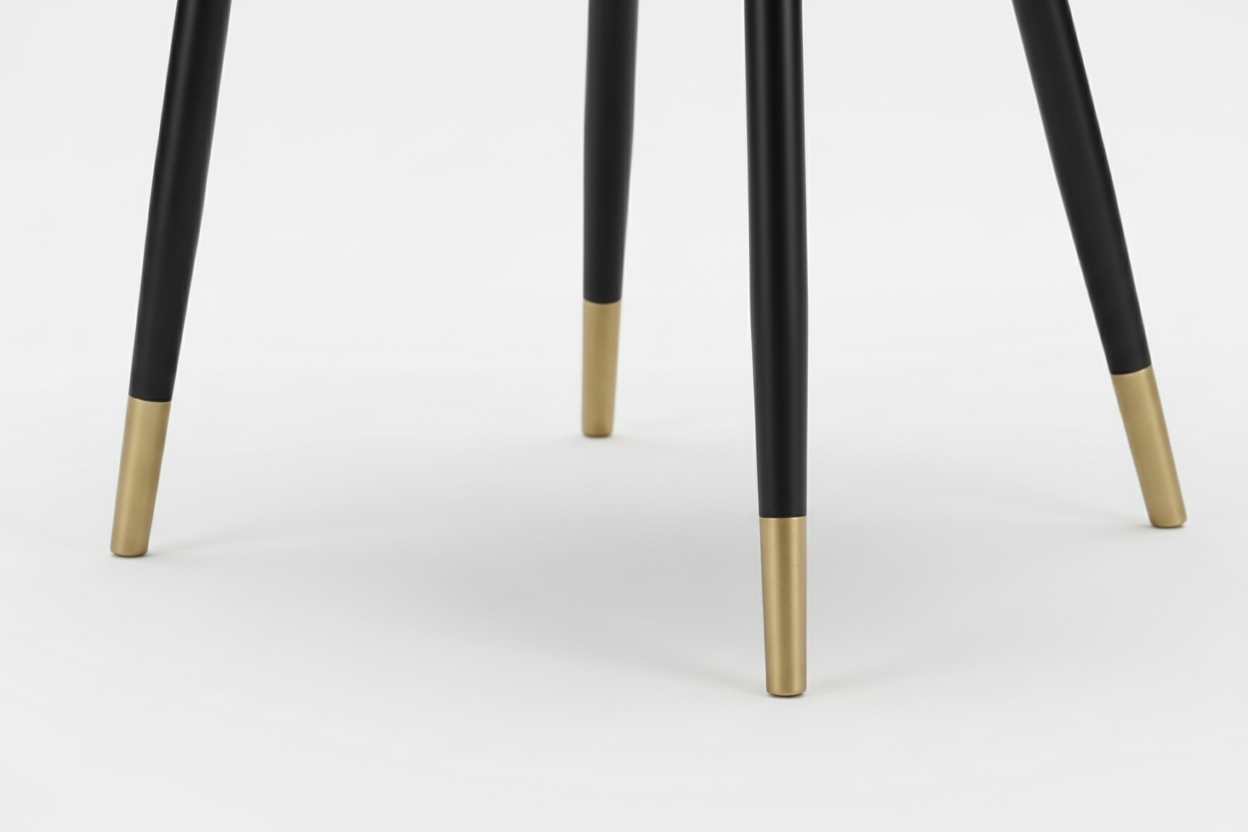 Blue upholstered chair with black legs and gold feet on a white background