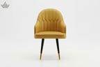 Mustard yellow chair with black legs on a white background