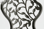 Decorative chair with intricate cut-out design on a white background