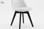 White chair with black legs on a white background