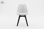White chair with black legs on a white background