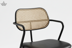 Chair with black frame and woven backrest on a white background