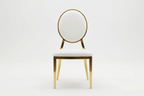 Gold chair with white cushion on a light gray background