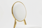 Gold chair with white cushion on a light gray background