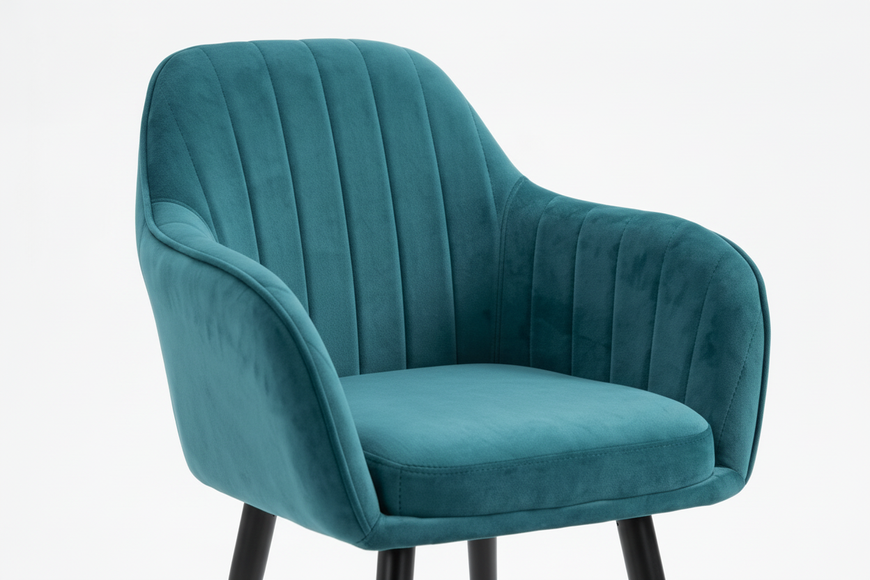 Teal velvet chair with black legs and gold feet on a white background