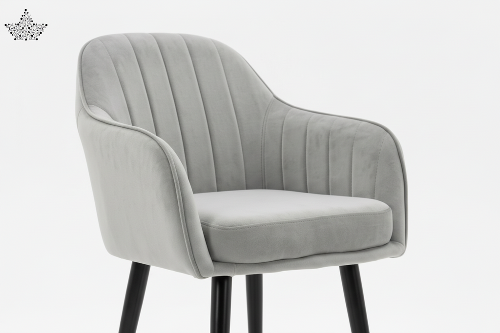 Gray upholstered chair with black legs and gold feet on a white background