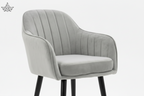 Gray upholstered chair with black legs and gold feet on a white background