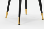 Gray upholstered chair with black legs and gold feet on a white background