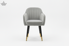 Gray upholstered chair with black legs and gold feet on a white background