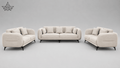 A three-piece modern sofa set in a light beige fabric, including a three-seat sofa, a two-seat loveseat, and matching accent pillows, shown on a neutral gray background.
