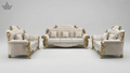 Luxurious white sofa set with gold accents on a gray background