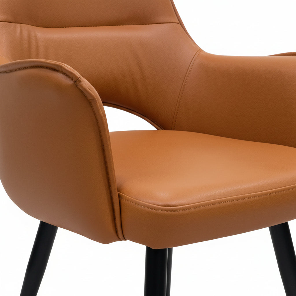 Brown leather chair with metal legs in a showroom setting