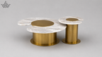Modern coffee table with marble top and gold cylindrical base on a gray background