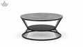 Round coffee table with a gray top and black metal base on a white background