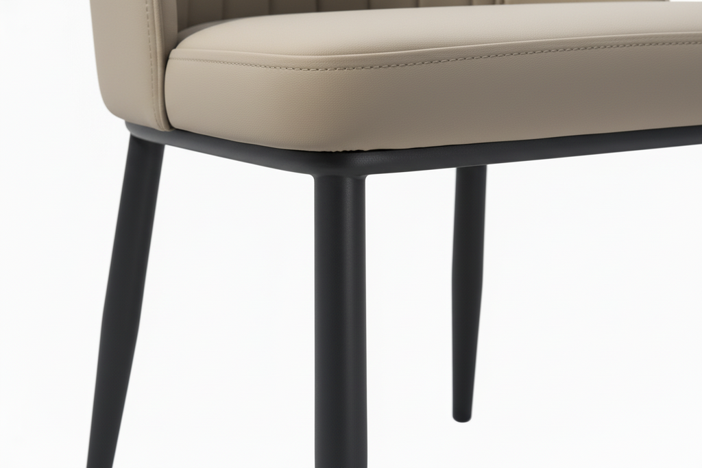 Beige upholstered chair with black legs on a white background