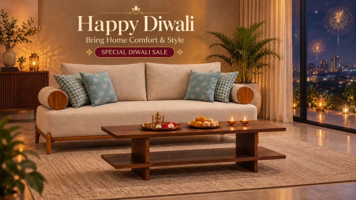 A beige upholstered sofa with blue patterned throw pillows in a warmly lit living room, with a wooden coffee table in front and a large window showing fireworks outside. Text at the top reads 'Happy Diwali Bring Home Comfort & Style' and 'SPECIAL DIWALI SALE'.