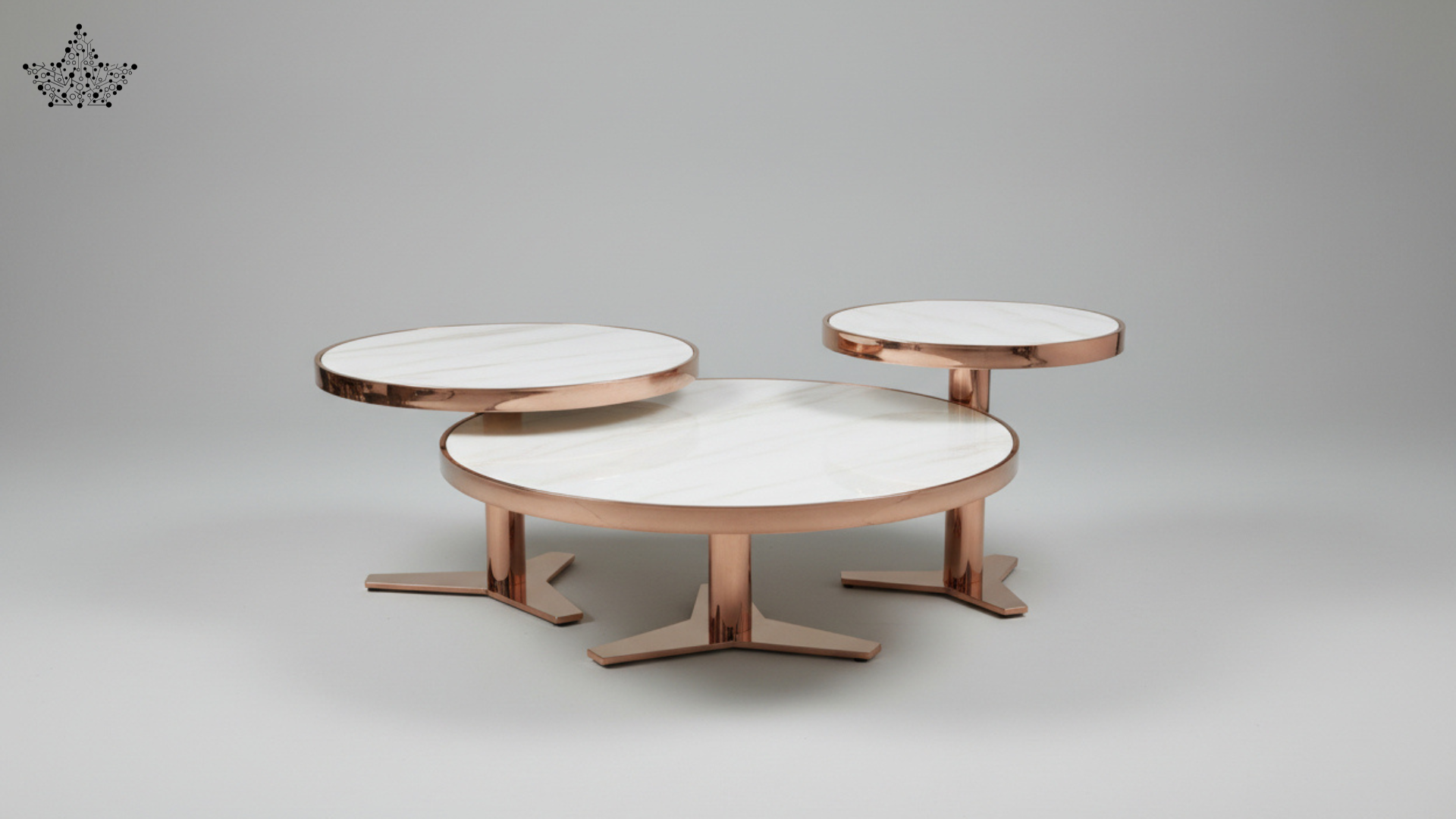 Three nested round nesting tables with white marble-look tops and rose gold metal bases, shown on a neutral gray background.