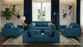 Blue sofa set in a living room with abstract art and a lamp.